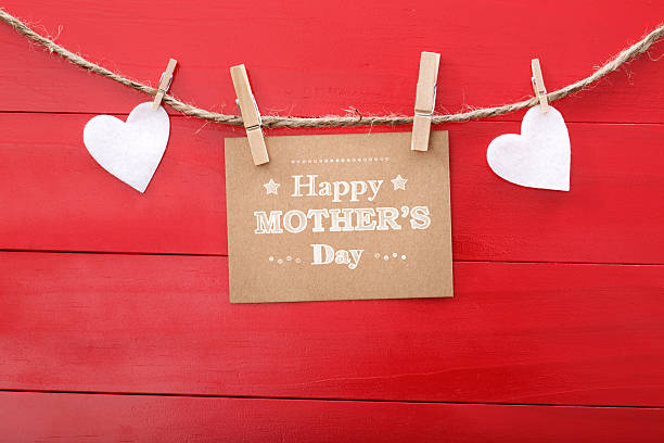 istock Mothers day message with felt hearts hanging with clothespins 467708530