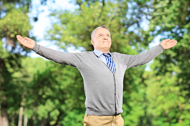 istock Happy gentleman spreading his arms in a park 467709171