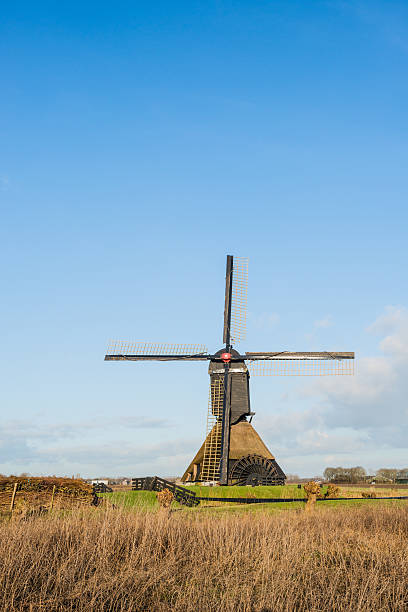 istock Dutch polder mill against a blue sky 467709264