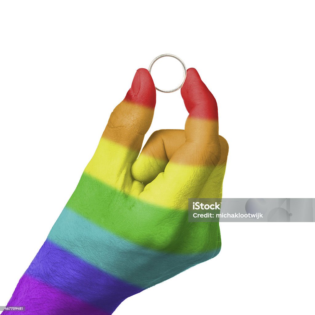 Gay man holding ring Man holding a silver ring, rainbow flag pattern Adult Stock Photo