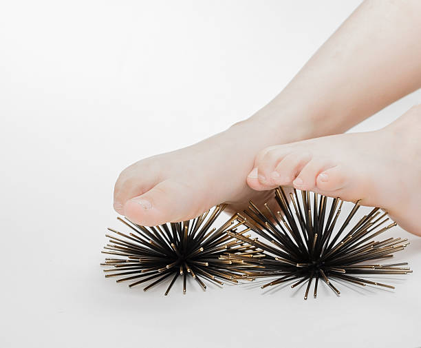 massage therapy on feet with help of artificial sea urchins stock photo