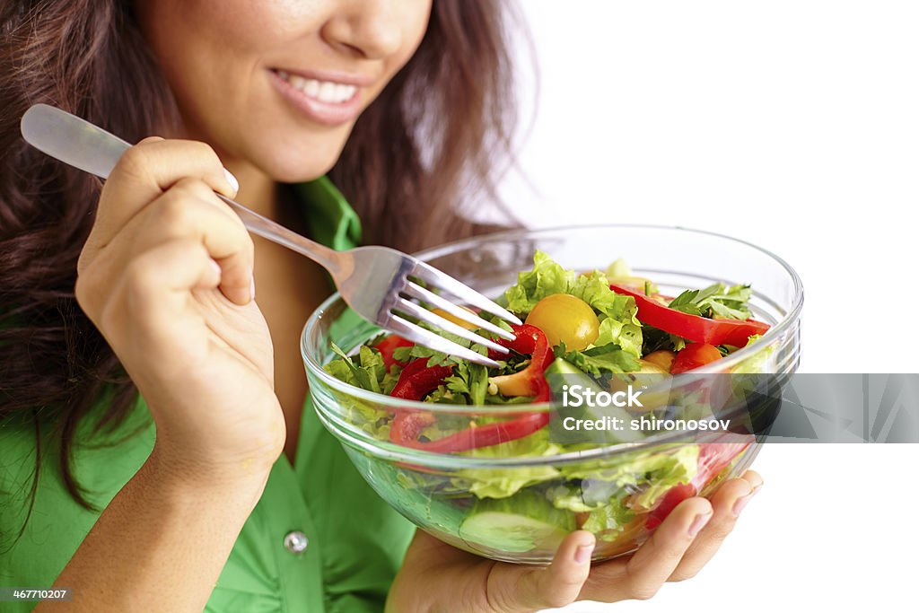 On a diet Close-up of pretty girl eating fresh vegetable salad Adult Stock Photo