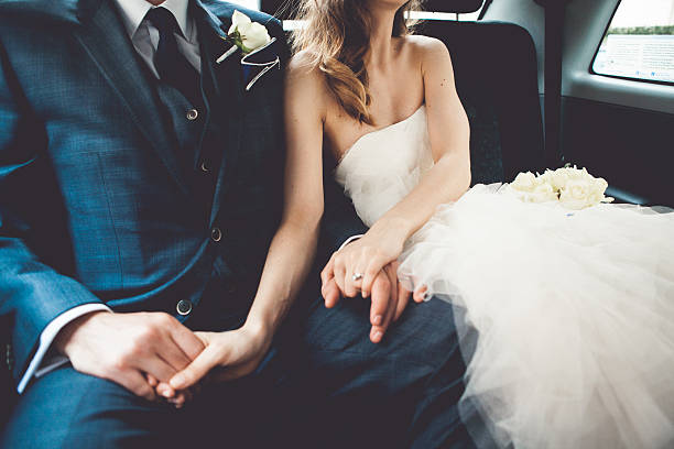 Bride and groom in a car For more wedding photos, please visit the lightbox below: chinese wedding dress stock pictures, royalty-free photos & images
