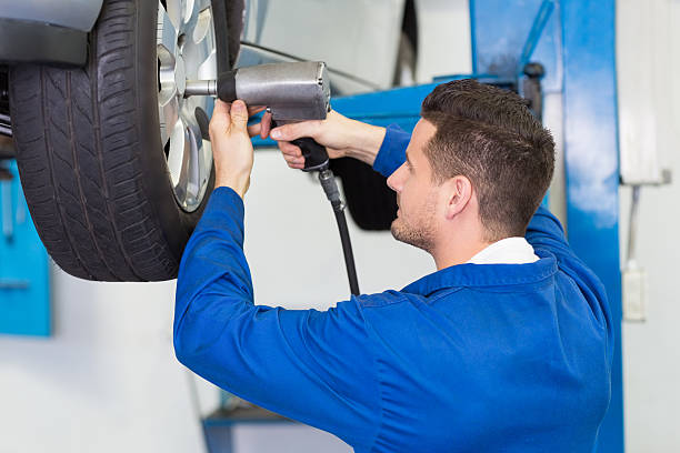 istock Mechanic adjusting the tire wheel 467712504