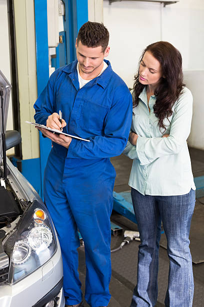 istock Mechanic and customer standing together 467712820