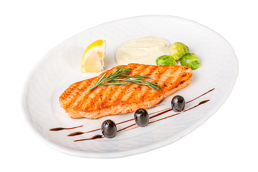 Fillet of salmon with vegetables on a white isolated background