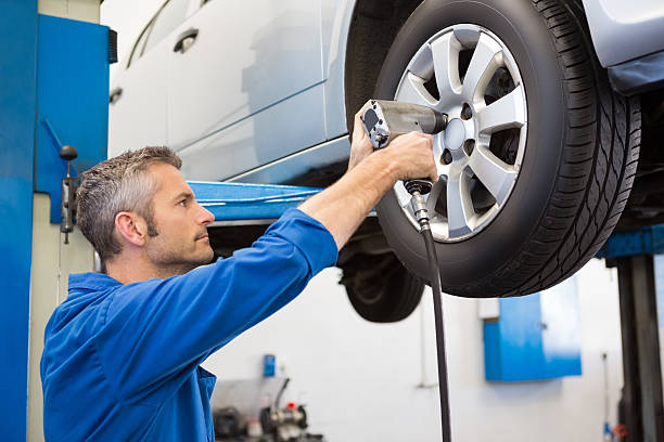 istock Mechanic adjusting the tire wheel 467713624
