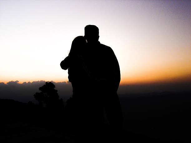 istock Couple silhouette at sunset 467714045