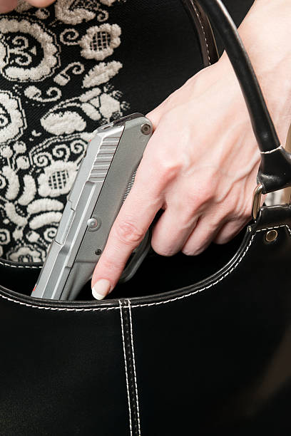concetto di arma nascosta - hiding carrying weapon handgun foto e immagini stock