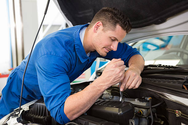 istock Mechanic examining under hood of car 467714230