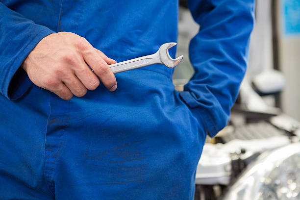 istock Mechanic standing with wrench in hand 467714286
