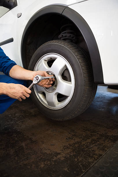 istock Mechanic adjusting the tire wheel 467715058