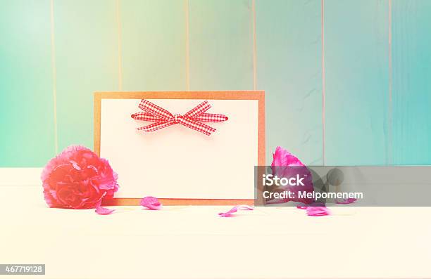 Card With Carnations On Teal Colored Wood Stock Photo - Download Image Now - 2015, Admiration, Auto Post Production Filter
