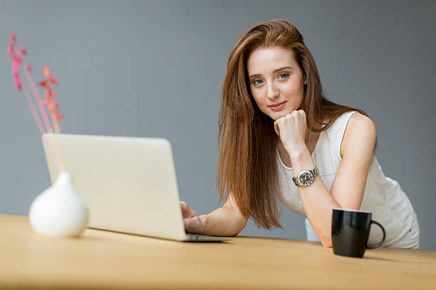 istock Young woman with laptop in the office 467719880