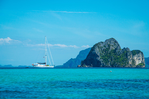 Yacht floating near the island.