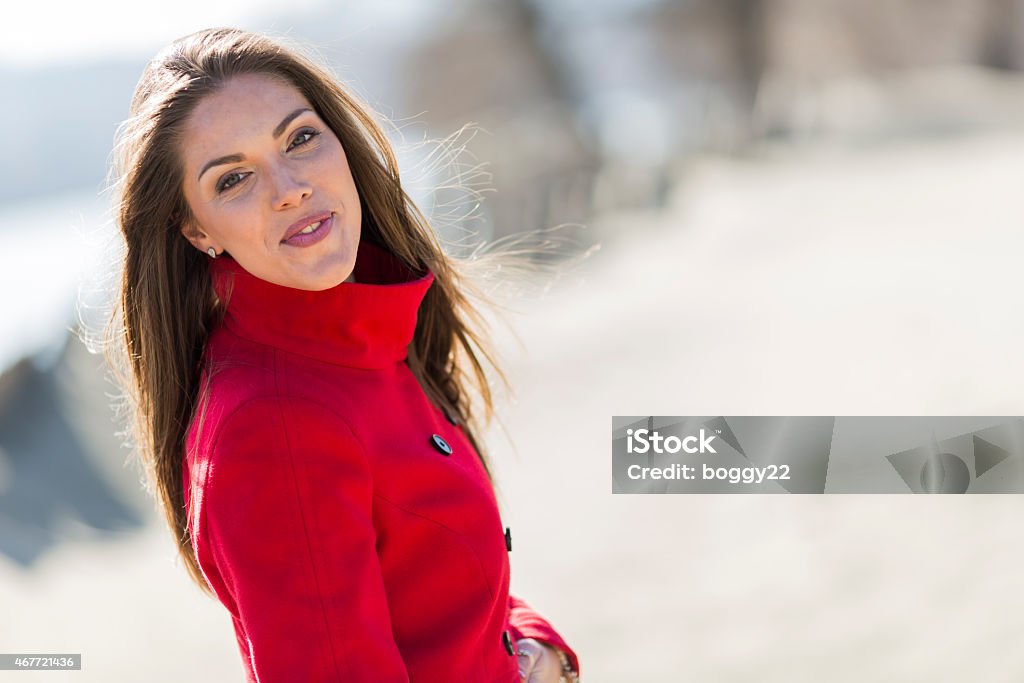 Pretty young woman in red coat 2015 Stock Photo