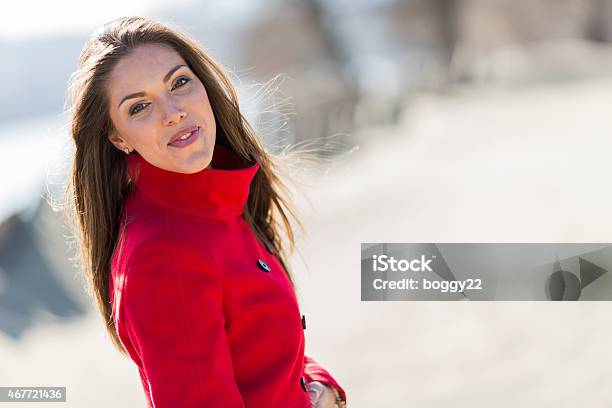 Pretty Young Woman In Red Coat Stock Photo - Download Image Now - 2015, Adult, Adults Only