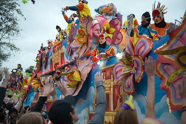 Mardi Gras parade by Krewe of Endymion New Orleans, USA - February 9, 2013: Costumed men on a float throw beads into the crowd during a Mardi Gras parade (Krewe of Endymion) on Canal Street in New Orleans, Louisiana parade float stock pictures, royalty-free photos & images