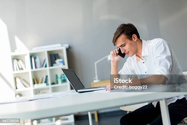 Young Man In The Office Stock Photo - Download Image Now - 2015, Adult, Adults Only