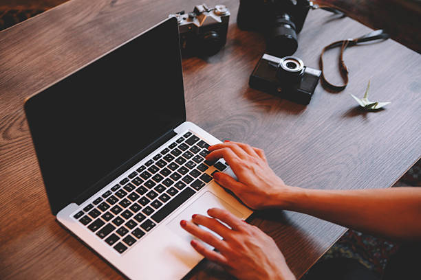 istock photographer working on a laptop behind desk 467729308