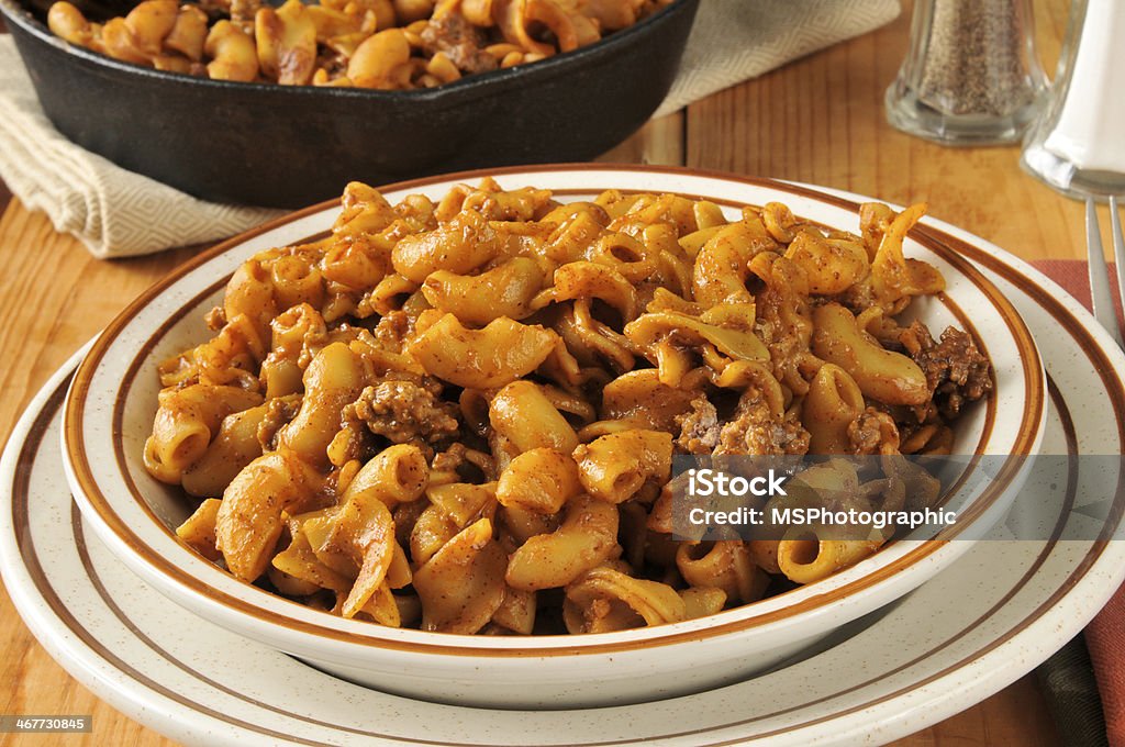 Skillet dinner Chili macaroni with a cast iron skillet in the background Macaroni Stock Photo