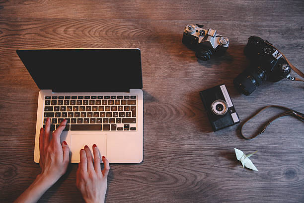 istock photographer working on a laptop behind desk 467736798