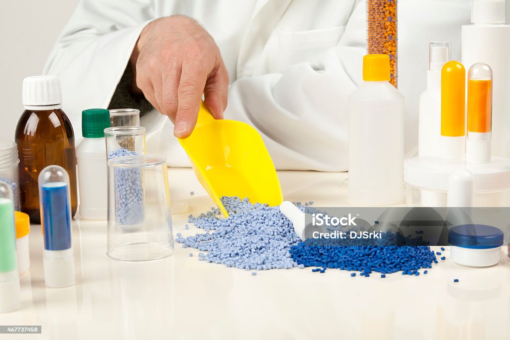 plastic granules technician working with plastic granules Plastic Stock Photo