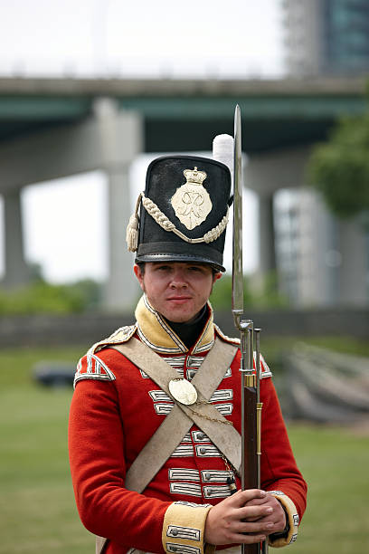 A Revolutionary War reenactor holding a reproduction of the rifle used during that war.