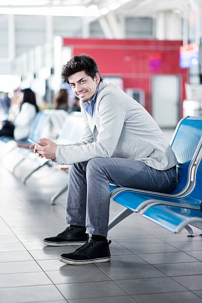 istock Young Businessman Using Mobile Smart Phone while Waiting at Airport 467743886