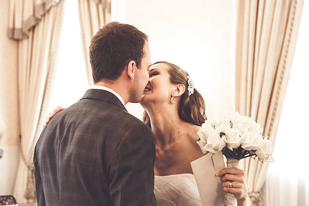 istock Bride and groom kissing in registry office 467744160