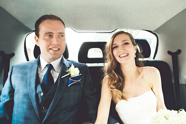 istock Bride and groom in a car 467744166
