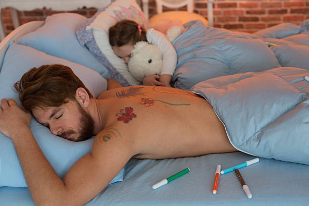 istock Cute daughter and her father sleeping in one bed. 467745960