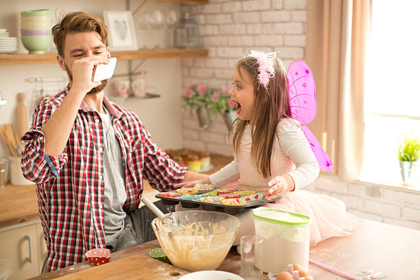 istock Father and daughter baking in kitchen. 467745984