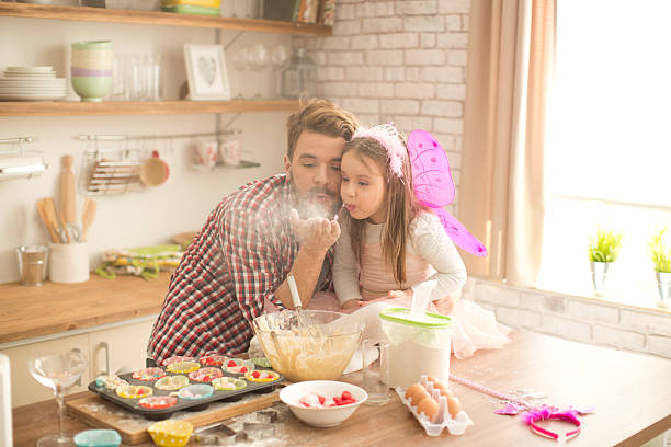 istock Father and daughter baking in kitchen. 467745994