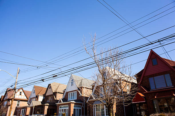 istock Unique Red House flanked by more brown Row Homes 467746346