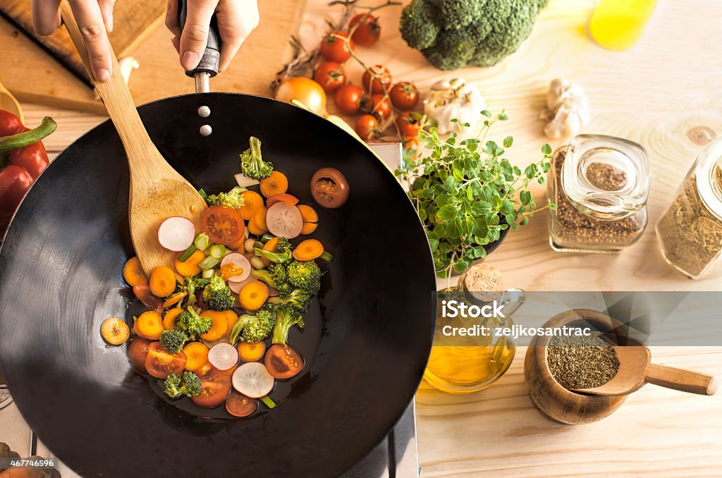 Chef cooking vegetables in wok pan Wok Stock Photo