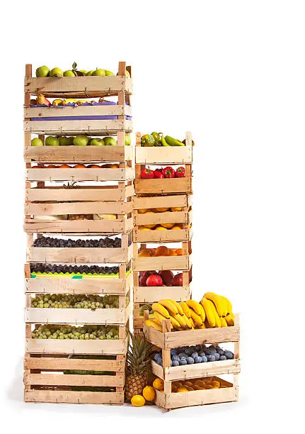 Photo of Fruit stored in wooden crates on white background