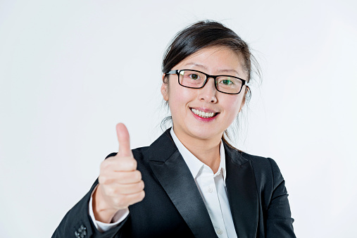 Asian businesswoman thumbs up, isolated on white background.