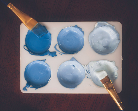 Paint palette with paint colors in various shades of blue