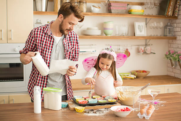 istock Father and daughter baking in kitchen. 467749560