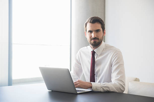 istock Confident Businessman Using Laptop At Conference Table 467749620