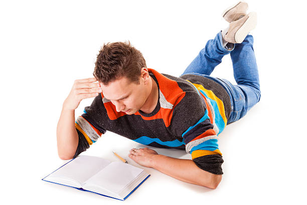 istock male student reading a book preparing for exam isolated 467750199