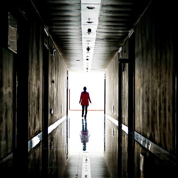 istock woman walking into the light 467750896