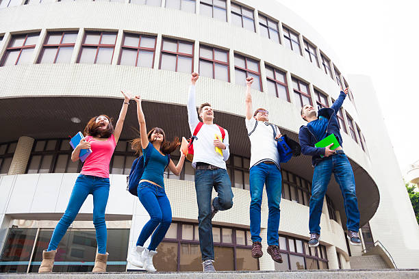 istock Happy young group of students jumping together 467751266
