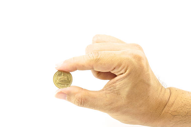 istock Hand of man holding gold coin 467751281