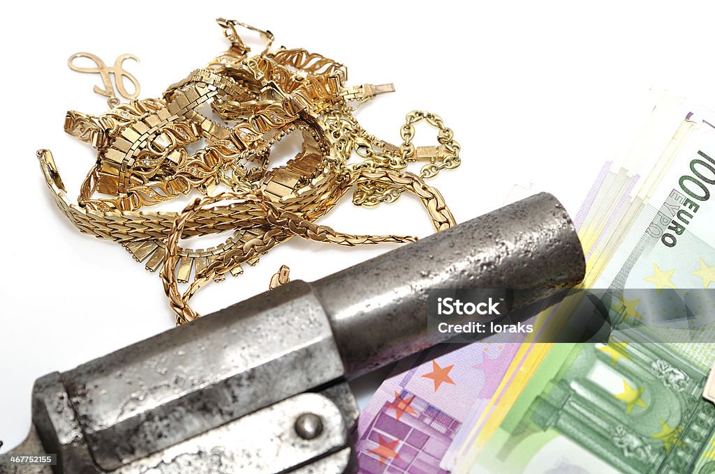 Gold money and a gun on white background. Treasure of gold and cash. European Union Currency Stock Photo