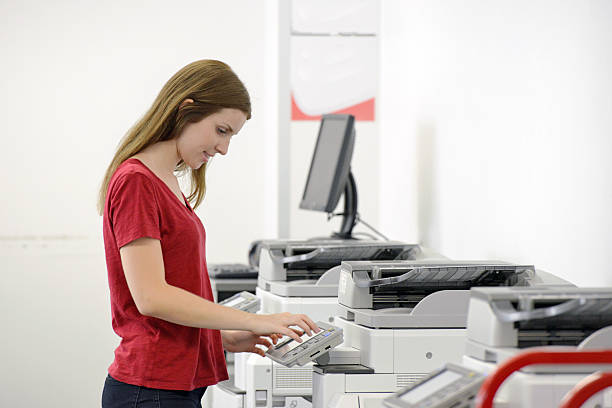 istock One young adult female using a high tech photocopier 467754512