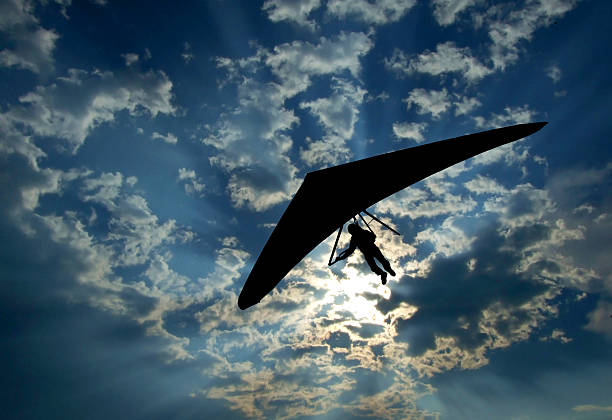 Hang glider silhouette on sky Hang glider silhouette on sky glider hang glider hanging sky stock pictures, royalty-free photos & images