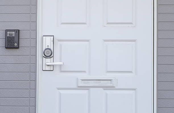 istock White wood door and brick wall background 467758710