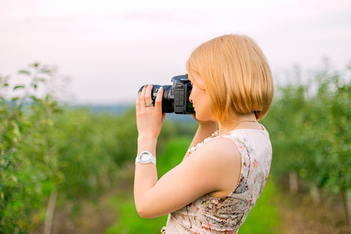 Girl photographing the surrounding landscape